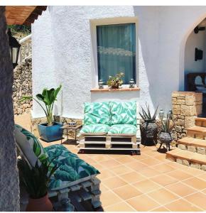 a couch sitting on a patio with a window at Casa Marieta in Benissa