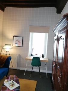 a living room with a desk and a window at "la suite" in Talant