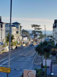 uma rua da cidade com um carro dirigindo por uma rua em The Patricia em Torquay