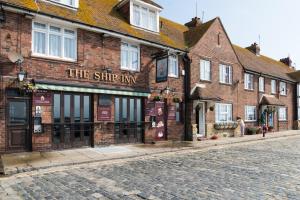 a brick building on the side of a street at The Ship Inn Folkestone in Folkestone