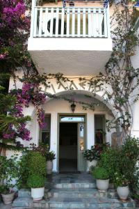 an entrance to a building with flowers and plants at Achilleion Hotel in Skiros