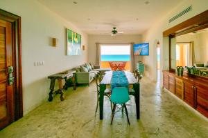 a living room with a table and a couch at Joe‘s Condo at Isla 33 in Isla Mujeres