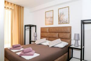 a bedroom with a large bed with two pillows on it at Villa Kajgo-Pag in Pag +110 photos