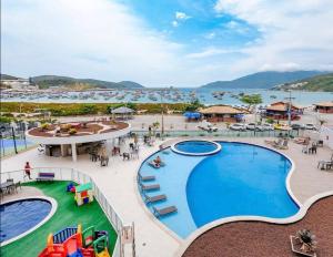 a view of a pool at a resort at Condomínio novíssimo com total estrutura para vc in Arraial do Cabo