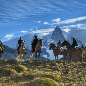 a group of people riding horses on a mountain at Estancia Bonanza Patagonian Lodge Experience in El Chalten