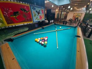 a pool table with balls on it in a restaurant at Tucan Hotel in Uvita