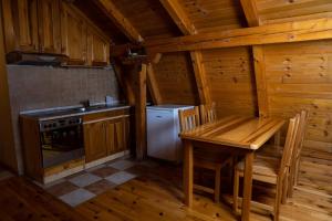 a kitchen with a table and a stove and a refrigerator at Apartments Peggy in Jahorina