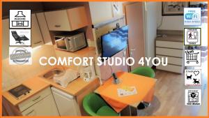 a small kitchen with a table and a tv at Appartements 4U Rodenbach in Rodenbach