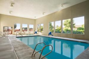 a swimming pool in a house with windows at Super 8 by Wyndham Kennewick in Kennewick