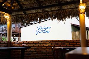 a sign that says dance twenties on a wall in a restaurant at Paraíso dos Ventos in Atins