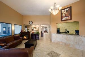 a living room with a fireplace and a couch at Super 8 by Wyndham Kennewick in Kennewick