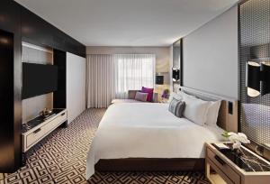 a hotel room with a large bed and a television at The Star Grand Hotel and Residences Sydney in Sydney