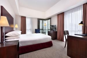 a hotel room with a bed and a desk at Hotel Capitol Kuala Lumpur in Kuala Lumpur