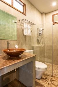 a bathroom with a sink and a toilet and a shower at Chapulin Natural Resort in Chiang Mai