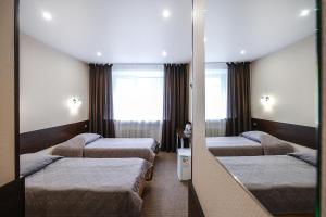 Posteľ alebo postele v izbe v ubytovaní Centralnaya Hotel