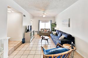 a living room with a couch and a tv at Dolphin Condominiums #12 in South Padre Island