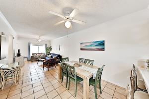 a dining room and living room with a table and chairs at Dolphin Condominiums #12 in South Padre Island