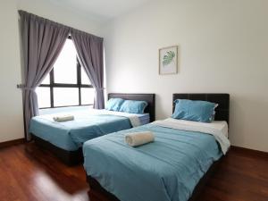 מיטה או מיטות בחדר ב-I-SOHO , I-City Shah Alam