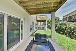 a patio with two chairs and a table at Moon Dancer Condominiums in South Padre Island