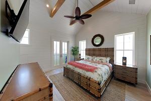 a bedroom with a bed and a ceiling fan at Turtle Ransas & Seaside Paradise in Port Aransas +74 photos