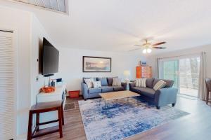 a living room with two couches and a tv at Chatuge Bell in Hiawassee