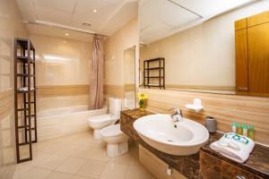 a bathroom with a sink and a toilet at Stylish and Sleek 1 Bed + Study near the JBR beach in Dubai