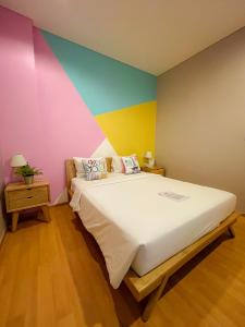 A bed or beds in a room at White Tree Residence