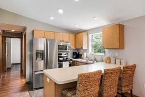 a kitchen with stainless steel appliances and wooden cabinets at Vacation Vibes in Marathon