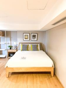 A bed or beds in a room at White Tree Residence