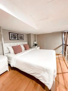 A bed or beds in a room at White Tree Residence