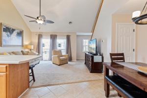 a kitchen and living room with a couch and a tv at Sand Dunes Delight in Myrtle Beach