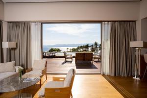 a living room with a view of the ocean at ON'LIVE HOTEL in Çeşme