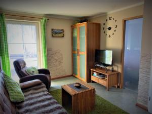 a living room with a couch and a tv at Ferienwohnung Unglert in Wertach +17 photos