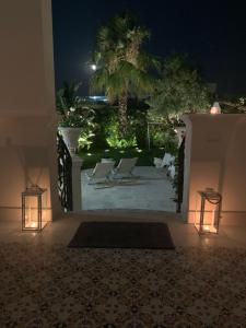 a view of a patio at night with lights at B&B Palma Salentina in Lizzano