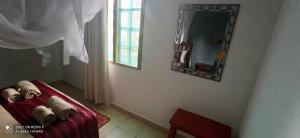 two teddy bears sitting on a red couch in a room at Tri M Waves Lodge in Ponta do Ouro