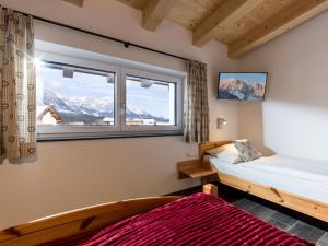 a bedroom with a bed and a window with mountains at Dani's Ferienwohnung in Söll