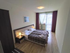 A bed or beds in a room at Nevada Aparthotel