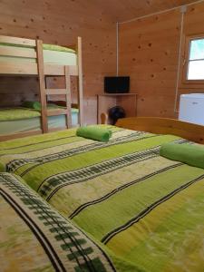a bedroom with two bunk beds in a cabin at SočaLand Glamping in Bovec