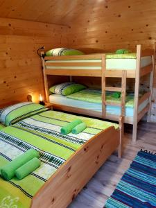 two bunk beds in a wooden cabin at SočaLand Glamping in Bovec