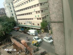 a view of a street with cars parked in front of a building at The CORPORATE in Kolkata