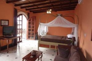 Säng eller sängar i ett rum på Hotel Casa Cubana Granada Nicaragua