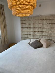 um quarto com uma cama com duas almofadas em Appartement lumineux, idealement situe - Enfants bienvenus ACTIVITES COMMERCIALES OU REMUNEREES INTERDITES em Namur