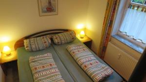 a bed in a bedroom with two pillows on it at Ferienwohnung Nordsee in Cuxhaven