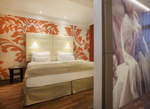 
A bed or beds in a room at Boutique Hotel Das Tigra
