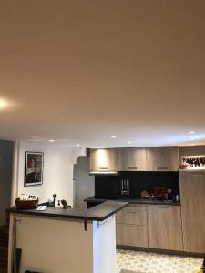 a kitchen with a counter top in a room at Charmante maison de village avec toit terrasse in Montalba-le-Château +13 photos