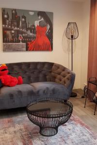a living room with a couch and a woman in a red dress at Apartment Luxus "Akzente-Art Minden" in Minden