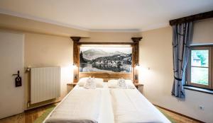 ein Schlafzimmer mit 2 Betten und einem Wandgemälde in der Unterkunft Landgasthof & Restaurant Batzenhäusl in Sankt Gilgen