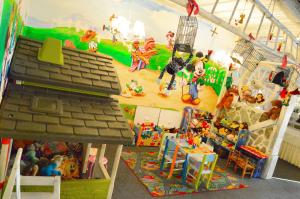 a room filled with toys and a toy house at Penzión Hoffer in Nitra
