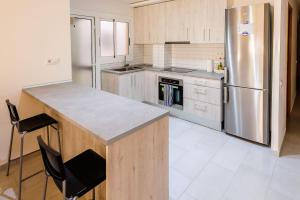 a kitchen with a stainless steel refrigerator and a counter at Carrer Sevilla in Tarragona