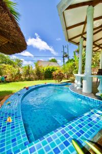 a swimming pool at a resort at La Petite Maison and Sea Splash in Anse Possession